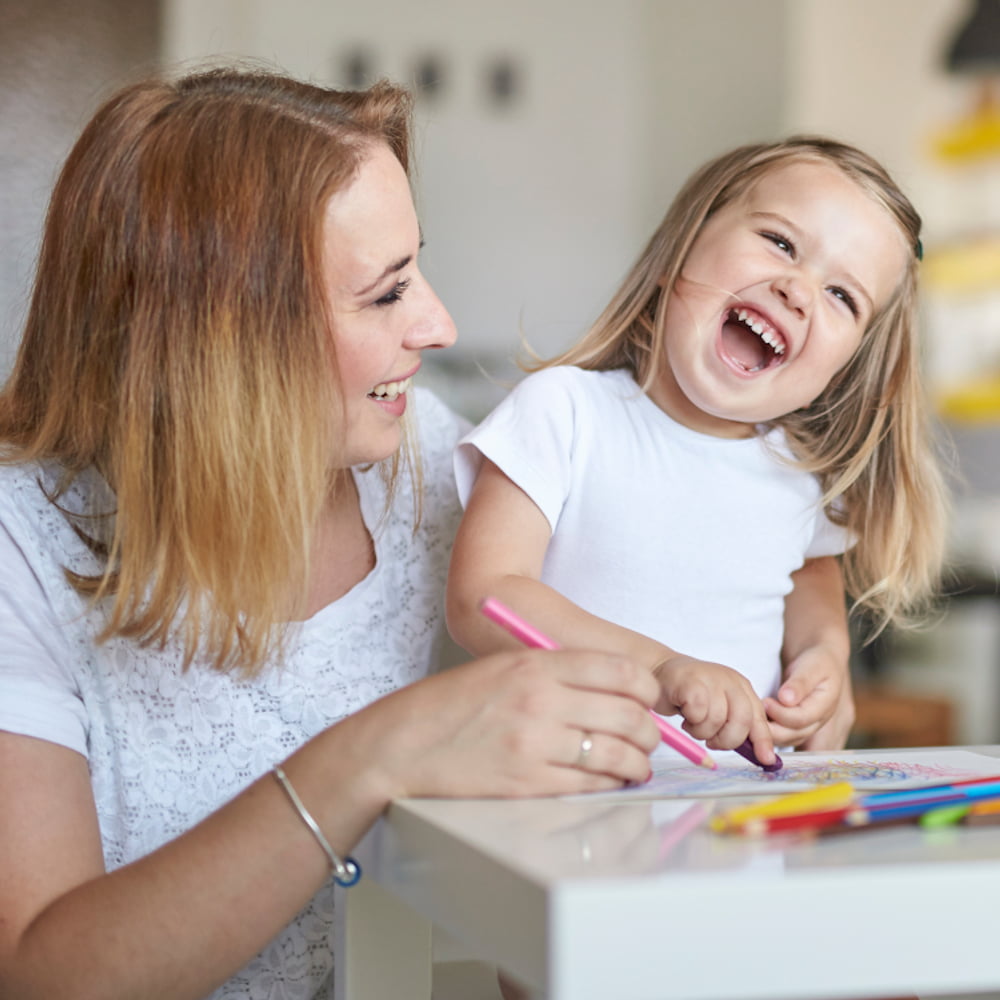 A mom and her little daughter drawing together