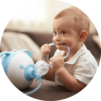 A boy with the Nosiboo Pro Electric Nasal Aspirator